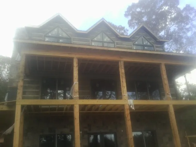 Dormers and porch framing on a large log home under construction in Wyocena